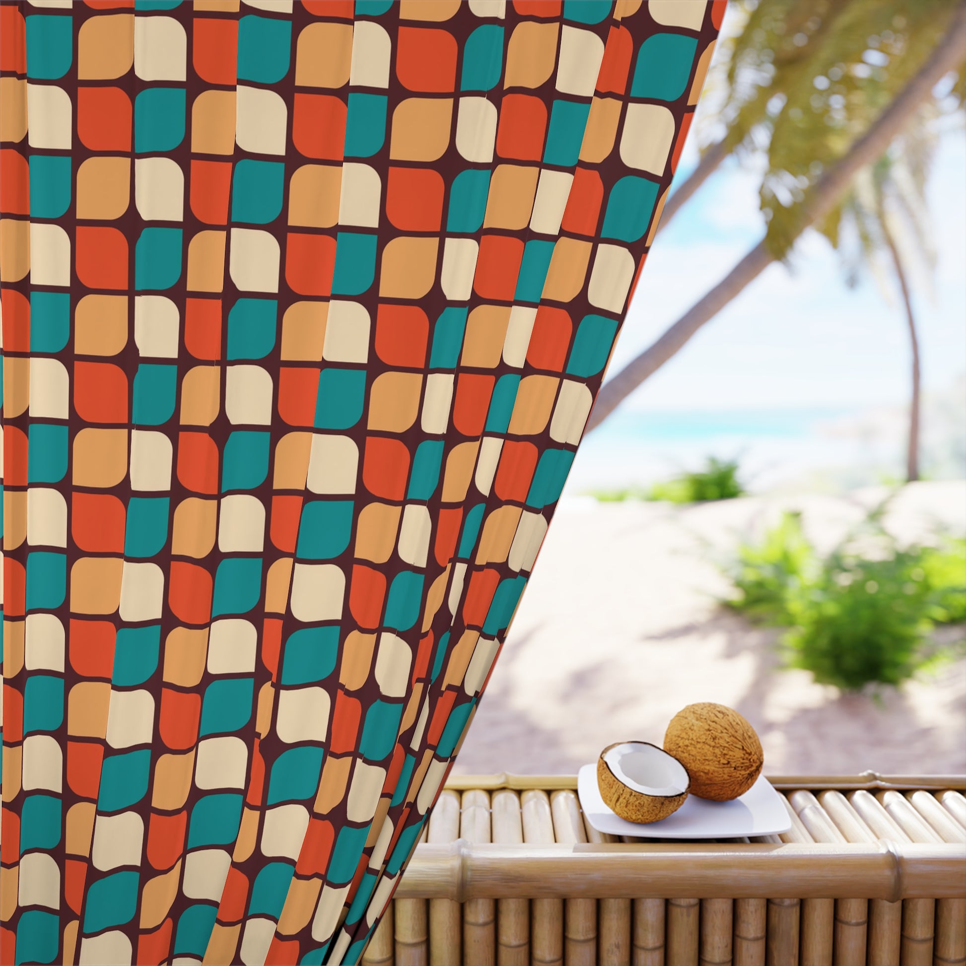 A colorful geometric patterned blackout window curtain panel is displayed in a room with a tropical beach background. The curtain covers a large window and there is a coconut fruit placed on a white tray in front of the curtain.