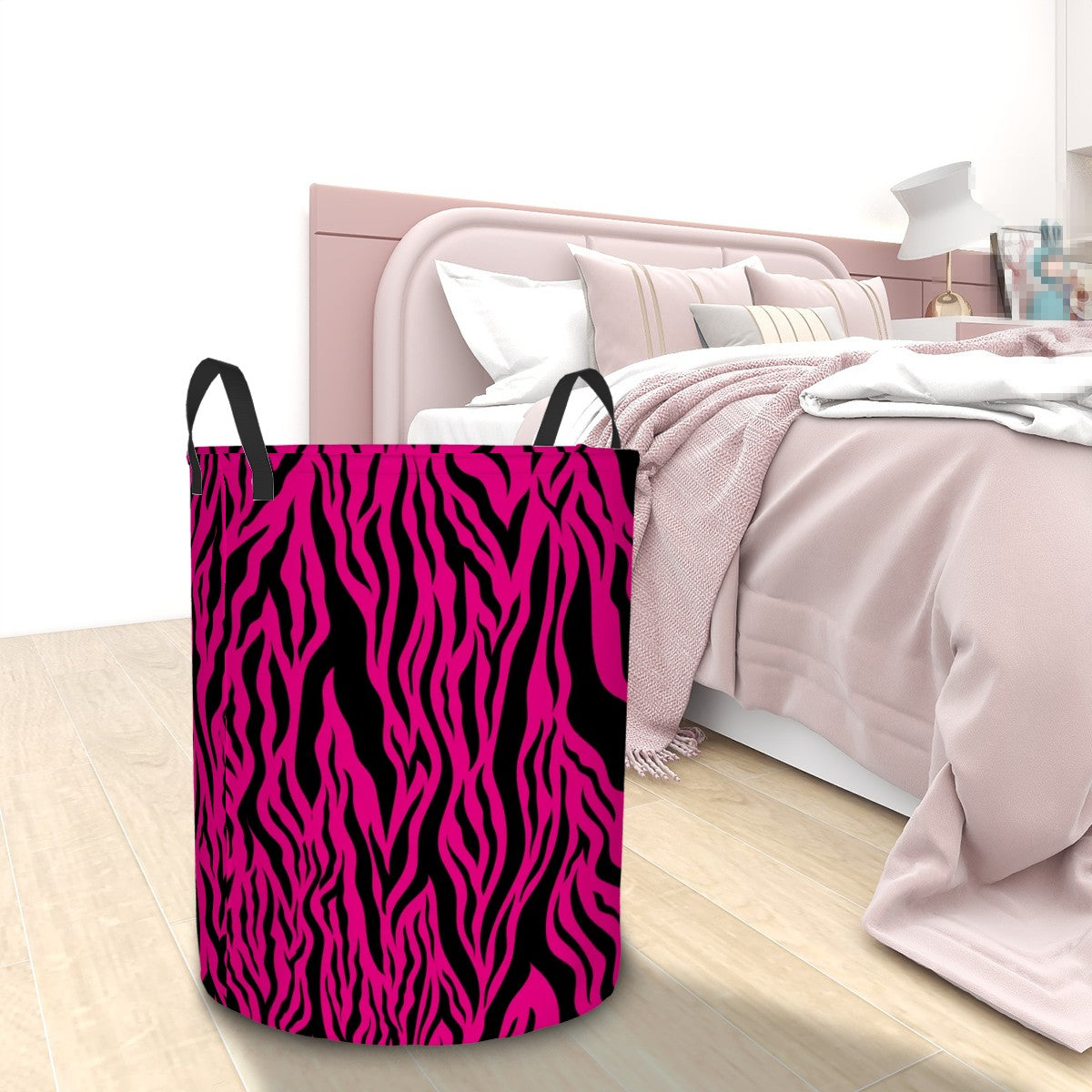 Pink and black tiger stripe animal print  pattern laundry basket in a bedroom setting
