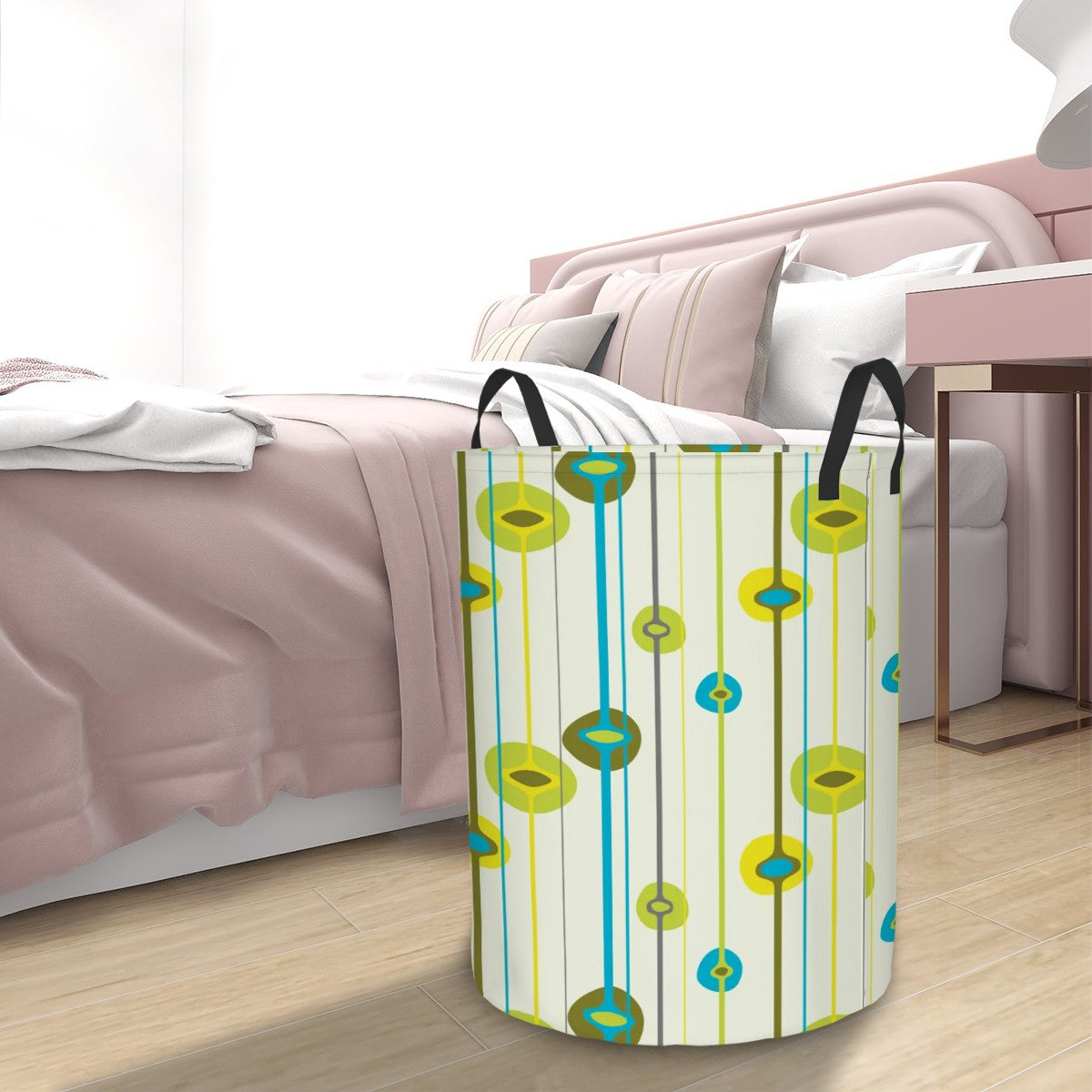 Colorful laundry basket with a retro pattern on a wooden floor next to a bed.